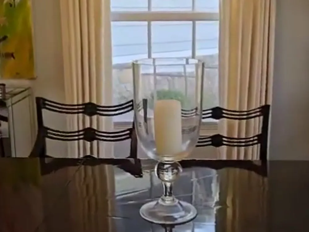 House cleaning service performed in the dining room, focusing on window and furniture cleanliness.
