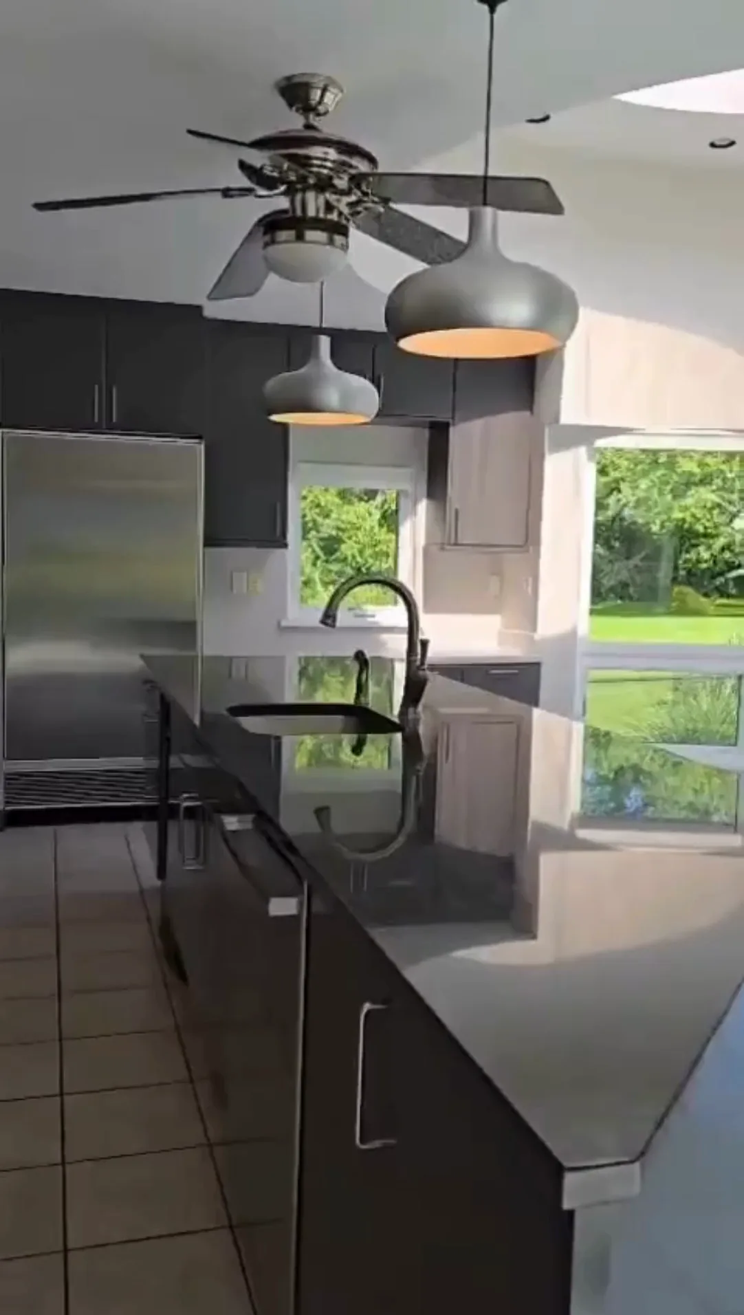 After complete kitchen cleaning, with spotless appliances, cabinets, hood, and lighting fixtures.