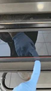 Before complete kitchen cleaning, showing dust and grime on appliances, cabinets, hood, and light fixtures.