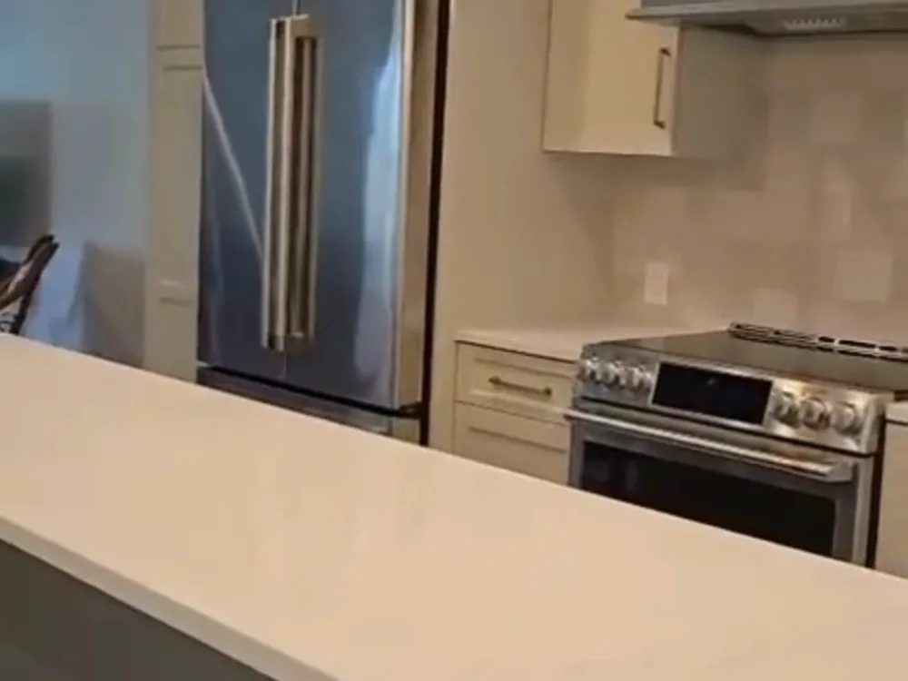 Complete Kitchen Cleaning: Another angle of the well-maintained kitchen, featuring modern appliances and a polished countertop.