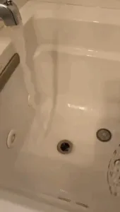 Bathtub deep cleaning in progress with water circulation