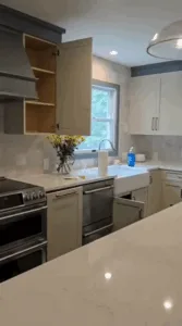 Complete Kitchen Cleaning: Bright kitchen with clean countertops, a vase of yellow flowers, and organized cabinets.