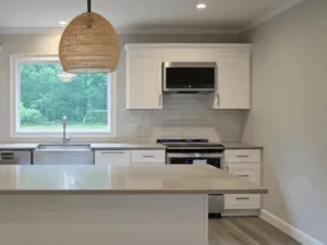 Modern kitchen after kitchen deep cleaning with bright countertops and stainless-steel appliances.