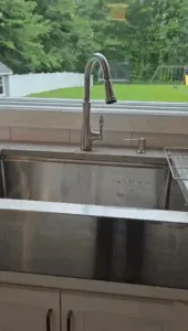 Stainless-steel sink shining after kitchen deep cleaning.