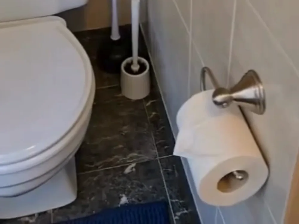 Bathtub with metal rack showing stains before Effective Bathroom Cleaning.