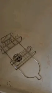 Toilet area with paper roll neatly placed before Effective Bathroom Cleaning.