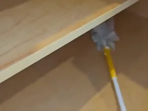 Kitchen cabinet cleaning highlighting sanitized and organized shelves