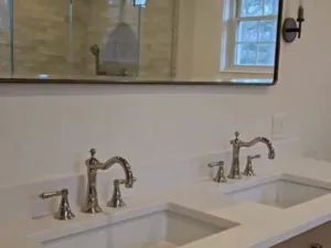 Bathroom Cleaning Service applied to double sink vanity with polished faucets