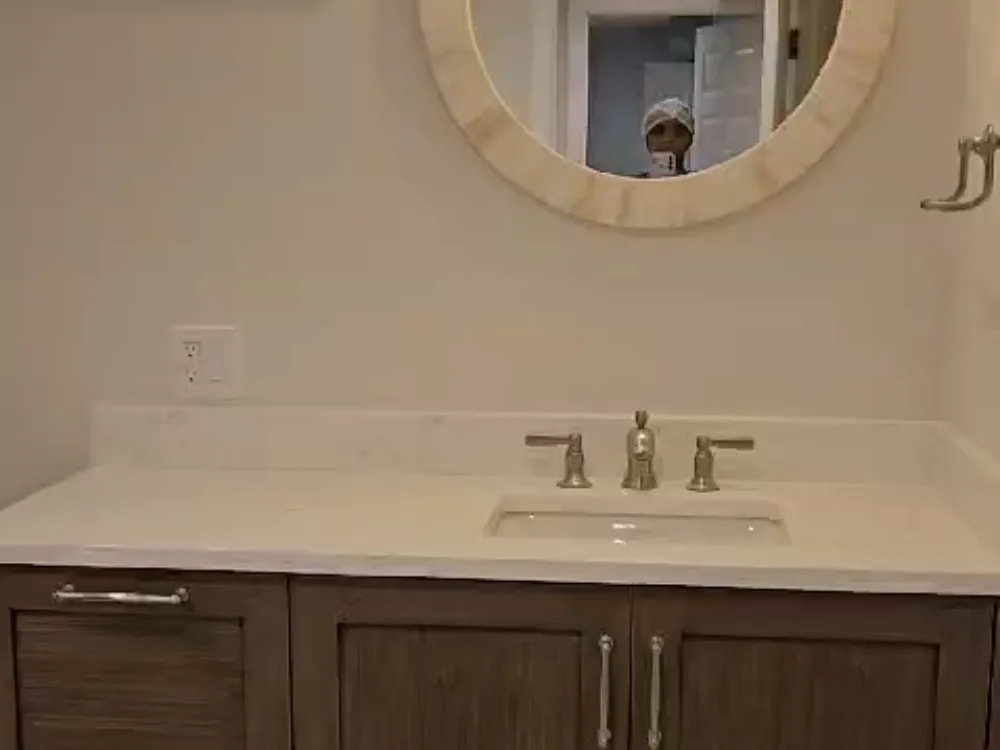Post-construction bathroom cleaning showcasing a clean vanity, sink, and countertop after renovation cleanup